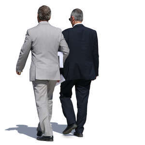 two older businessmen in suits walking side by side