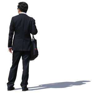 asian businessman in a black suit standing