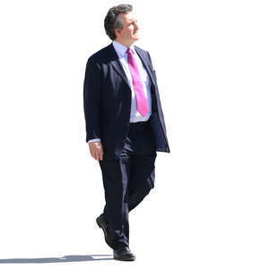 older businessman walking on a sunny day