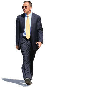 businessman in a dark blue suit walking