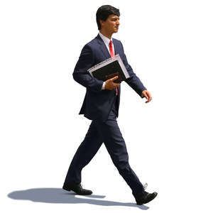 businessman with notebook under his arm walking hastily