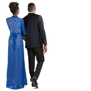 african couple in formal attire walking arm in arm