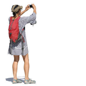 woman in a summer dress taking pictures
