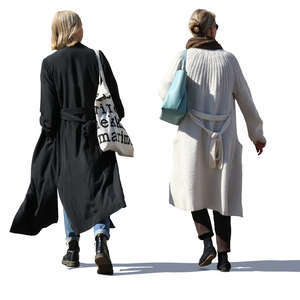 two women in long jackets walking