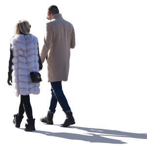 backlit man and woman walking