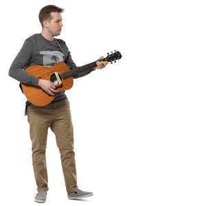 man standing and plying a guitar