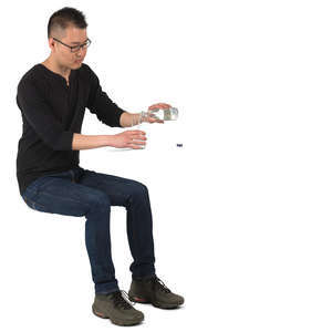 asian man sitting and pouring water in the glass