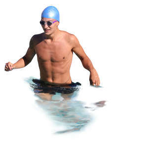 man with a swim cap and goggles standing in water