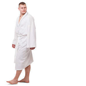 man in a white bathrobe walking