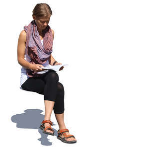 woman sitting in sunlight and reading a book