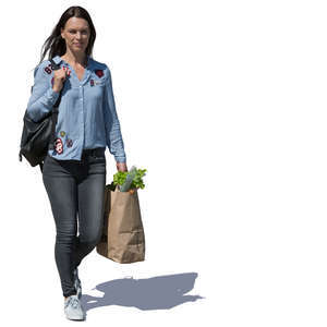 woman with a bag of groceries walking