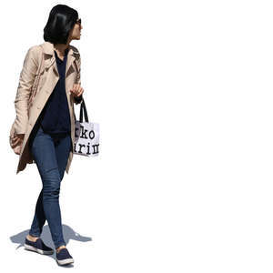 woman walking and carrying a shopping bag
