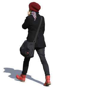 young woman with a red hat walking and talking on the phone