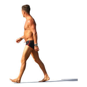 man in a swimsuit walking on the beach