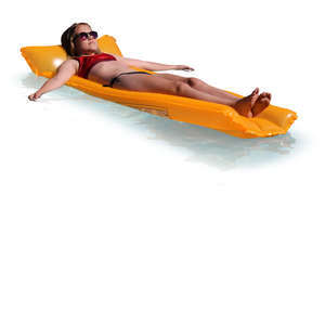 teenage girl floating on a swimming mattress