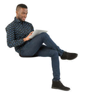 african man sitting and working with tablet