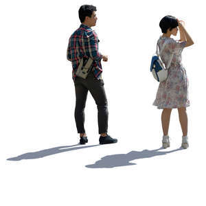 asian couple standing and looking at smth