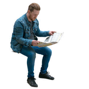 man sitting and reading a newspaper