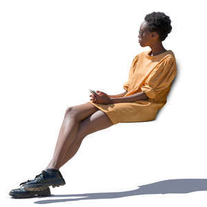 african woman in a yellow dress sitting