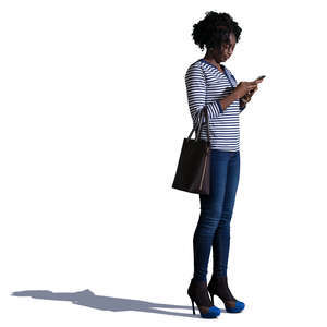 african woman standing and texting