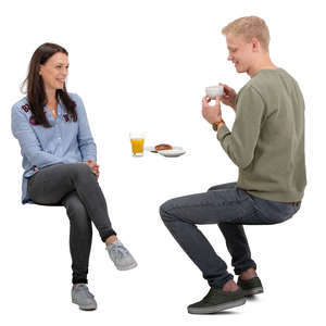 man and woman sitting and talking in a cafe