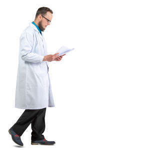 male doctor walking and reading papers