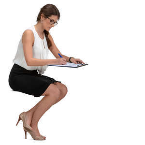 businesswoman sitting at a desk and writing