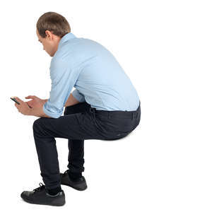 young man sitting and texting