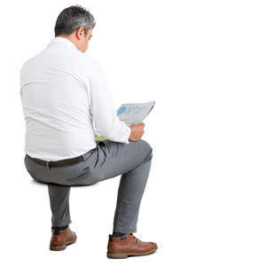 businessman sitting and reading a newspaper