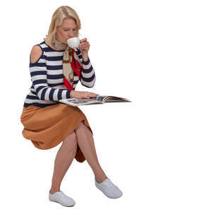 woman drinking coffee and reading a magazine