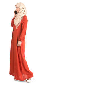 muslim woman in an orange abaya talking on the phone