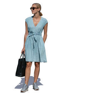 woman in a light blue summer dress standing