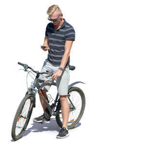 man with a bicycle standing and checking his phone