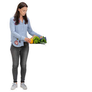 woman laying vegetables on a kitchen table