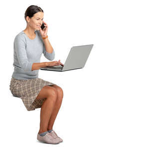 woman sitting at an office desk and working with a computer