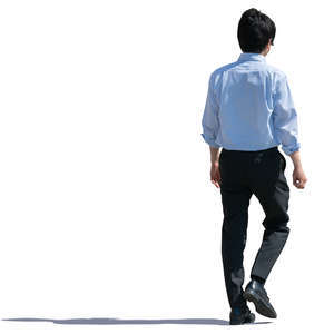 backlit asian man walking