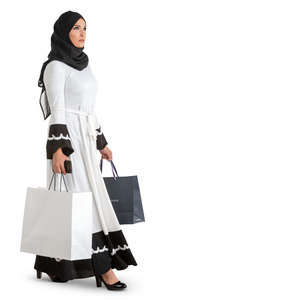 muslim woman in a black and white costume walking