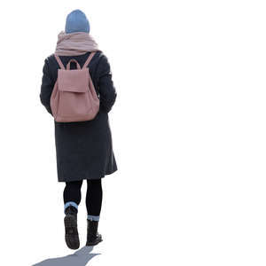 backlit woman with a pink backpack walking