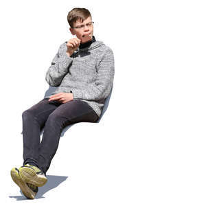 teenage boy sitting and eating ice cream