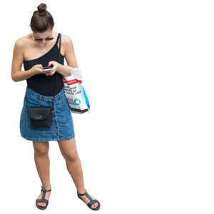 woman standing and looking at her phone seen from above