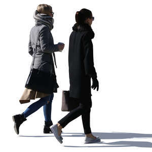 two sidelit women walking