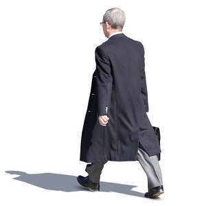 businessman in a black overcoat walking on the street