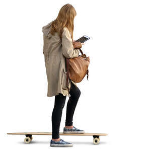 young woman standing on a skateboard and looking at ipad