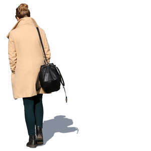 woman in a beige overcoat walking