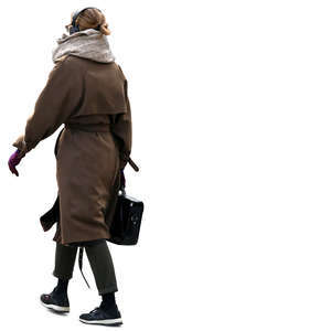 woman with headphones and a large scarf walking