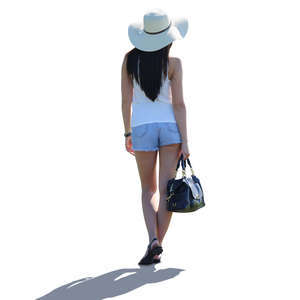 backlit woman with a big hat standing