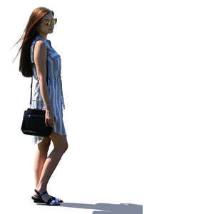 backlit woman in a summer dress standing