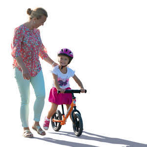 backlit mother and daughter with a likeabike