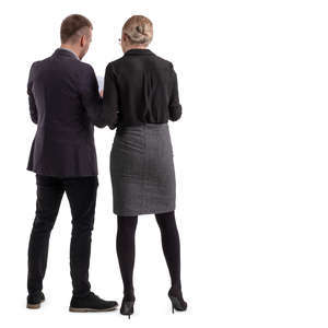 office workers standing and looking at some papers