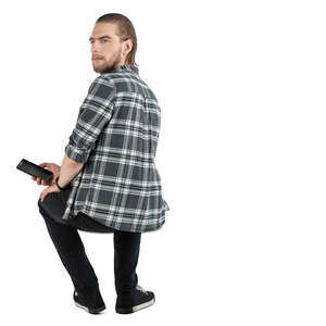 man sitting and looking over his shoulder